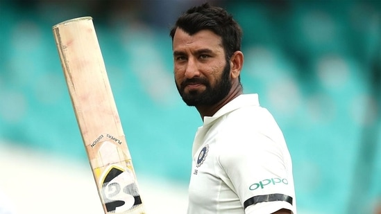 Cheteshwar Pujara raises his bat after a century. (Getty Images)