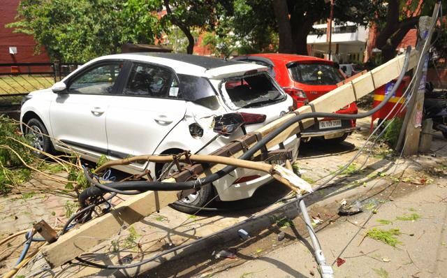Cars damaged after an electricity pole fell on them in Sector 46. Cars damaged after an electricity pole fell on them in Sector 46.