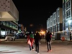 Three men walk down a road in the Greenwood district in Tulsa, Oklahoma, on May 30. Three men walk down a road in the Greenwood district in Tulsa, Oklahoma, on May 30.