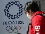 A man walks by the logo of the Tokyo Olympics, in Tokyo,(AP) A man walks by the logo of the Tokyo Olympics, in Tokyo,(AP)