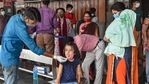 A medical worker collects swab sample of a child passenger for Covid-19 test in Lucknow. It is among the 14 districts where Covid restrictions will continue.(PTI Photo) A medical worker collects swab sample of a child passenger for Covid-19 test in Lucknow. It is among the 14 districts where Covid restrictions will continue.(PTI Photo)