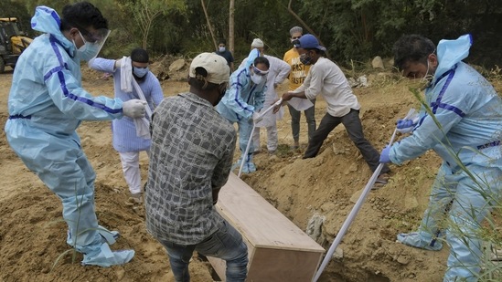 In the purported video, the three were seen carrying the body to the field in an excavator along with the cot on which their father had died. (AP representative image) In the purported video, the three were seen carrying the body to the field in an excavator along with the cot on which their father had died. (AP representative image)