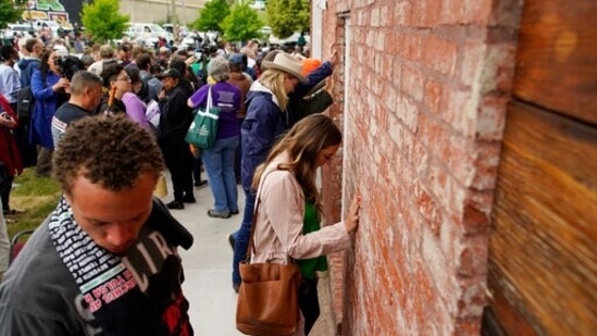 As the ceremony came to an end, participants put their hands on the prayer wall along the side of the sanctuary.(AP) As the ceremony came to an end, participants put their hands on the prayer wall along the side of the sanctuary.(AP)
