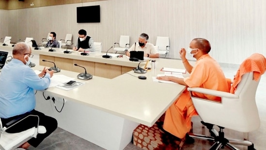 Uttar Pradesh chief minister Yogi Adityanath holds a meeting with chairpersons of the Covid-19 committee, at his residence in Lucknow on Saturday. (PTI Photo) Uttar Pradesh chief minister Yogi Adityanath holds a meeting with chairpersons of the Covid-19 committee, at his residence in Lucknow on Saturday. (PTI Photo)
