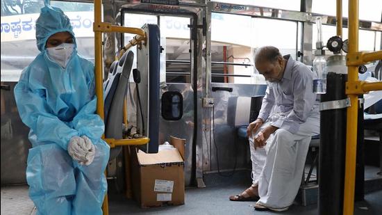 Bengaluru: A health worker keeps a check on a COVID-19 patient recieving oxygen in a bus, in Bengaluru, Saturday, May 15, 2021. (PTI Photo) (PTI05_15_2021_000266B) (PTI)
