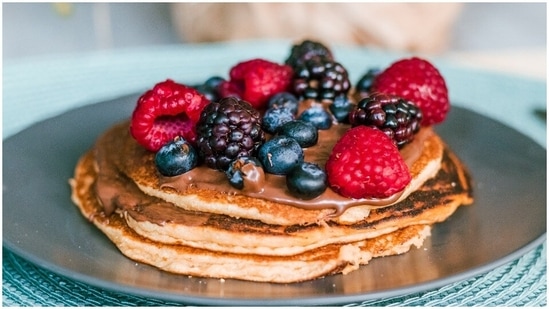 Pancake (4 servings): Take 1 banana and mash it in a bowl. Then add 2 eggs and a tablespoon of cinnamon powder and mix well. Add a spoonful of the batter to a nonstick pan and cook for 3-4 minutes on each side. Top it with honey or maple syrup.(Unsplash)