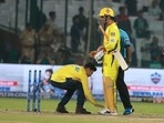 A fan touches MS Dhoni's feet during an IPL 2018 match: File photo