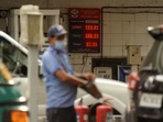 An attendant at a petrol pump, with fuel rates displayed behind him on a digital screen as petrol price reached new highs in Mumbai in this file picture from Saturday. An attendant at a petrol pump, with fuel rates displayed behind him on a digital screen as petrol price reached new highs in Mumbai in this file picture from Saturday.