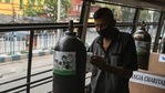 A man arranges an oxygen cylinder inside a bus converted into a mobile centre for Covid-19 coronavirus patients in Kolkata. (AFP) A man arranges an oxygen cylinder inside a bus converted into a mobile centre for Covid-19 coronavirus patients in Kolkata. (AFP)