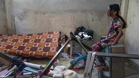 Amal Nassir, 11, sits for a portrait in her bedroom that was damaged by an airstrike during the conflict, on May 26 in Beit Hanoun, Gaza Strip. Both sides say they have no choice, and no one expects this war to be the last. Meanwhile, the intractable conflict takes its toll on those with the least capacity to understand its cruel logic.(John Minchillo / AP)