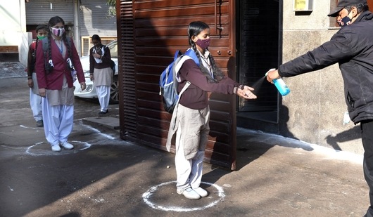 A student sanitizes her hands before entering Government Girls Sr. Secondary School no. 2, at Gandhi Nagar, in New Delhi in this file picture from February 2021. (Arvind Yadav/ Hindustan Times/For Representational Purposes Only) A student sanitizes her hands before entering Government Girls Sr. Secondary School no. 2, at Gandhi Nagar, in New Delhi in this file picture from February 2021. (Arvind Yadav/ Hindustan Times/For Representational Purposes Only)