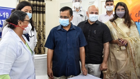 CM Kejriwal interacts with medics at a vaccination centre. (ANI Photo)