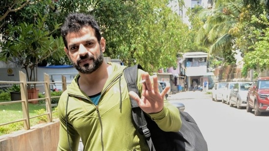 Karan Patel waves for photographers.