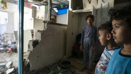 Batul Al-Masri, 5, and her siblings stand for a portrait in their bedroom that was damaged during an airstrike prior to a cease-fire, on May 26, 2021, in Beit Hanoun, Gaza Strip. The survivors have even more hardship ahead as they struggle to rebuild. Israel and Egypt have imposed a crippling blockade on Gaza since Hamas seized power from rival Palestinian forces in 2007.(John Minchillo / AP)