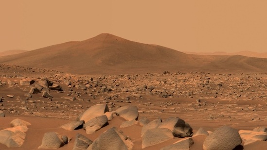 This photo shows Nasa's Perseverance Mars rover using its dual-camera Mastcam-Z imager to capture this image of "Santa Cruz," a hill about 1.5 miles (2.5 kilometres) away from the rover. The entire scene is inside of Mars' Jezero Crater; the crater's rim can be seen on the horizon line beyond the hill.(NASA/JPL-Caltech)