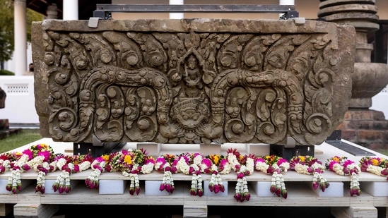 An ancient sandstone lintel, a sacred late 10th or 11th century sandstone support beam, is pictured at the Bangkok National Museum during an event to mark their return from the United States to Thailand, in Bangkok on May 31, 2021.(Photo by Jack TAYLOR / AFP)