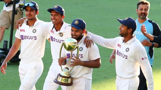 India's Rishabh Pant carries the trophy as he celebrates with his teammates after defeating Australia(AP)