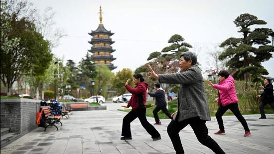 A file photo of people practising tai chi along a street in Rugao, in China's Jiangsu province. (AFP)