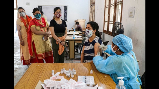 A health worker giving a Covid vaccine shot to a woman in Jammu on Tuesday. (PTI) A health worker giving a Covid vaccine shot to a woman in Jammu on Tuesday. (PTI)