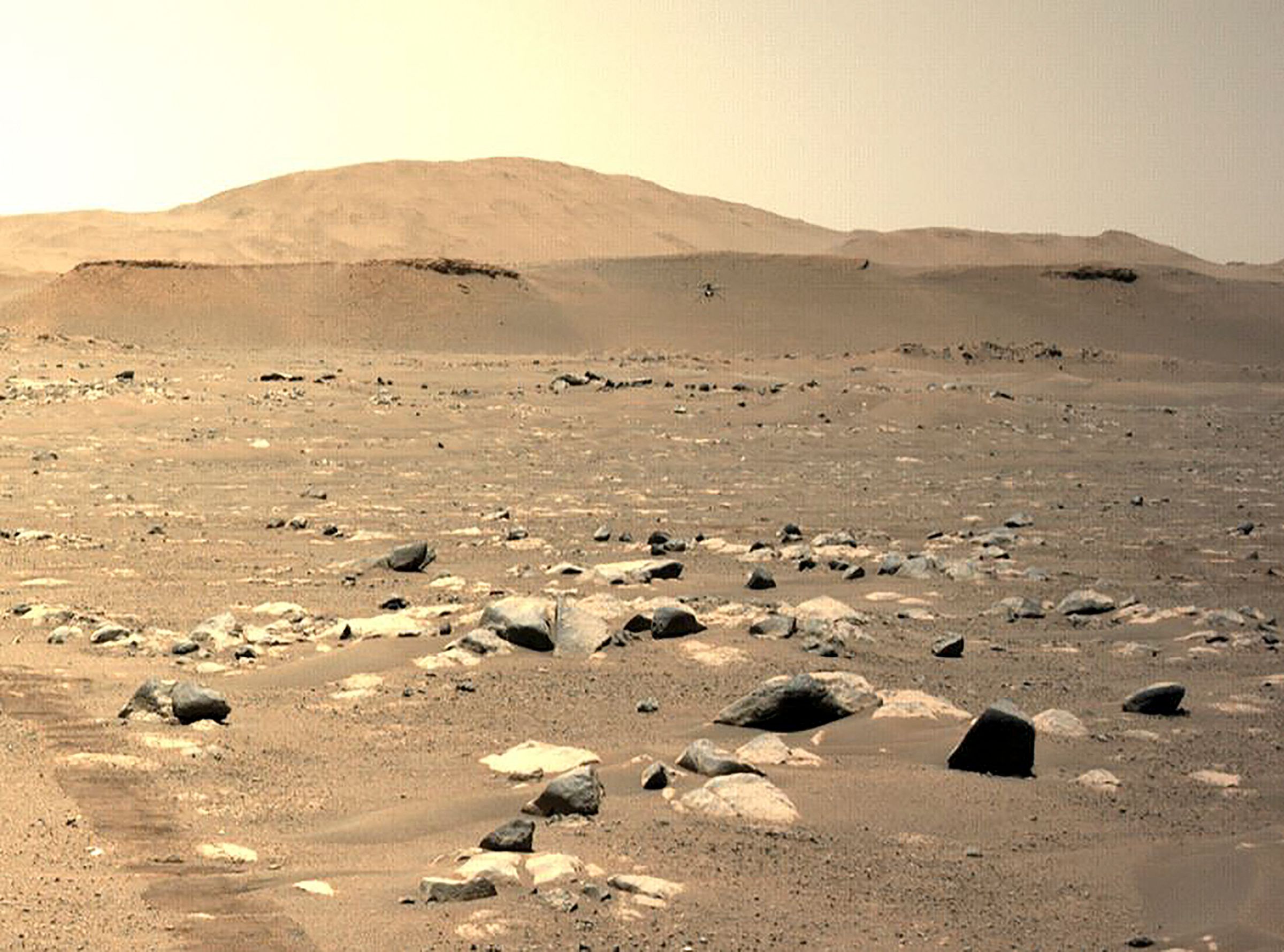 This photo shows Nasa's Ingenuity Mars Helicopter seen hovering during its third flight on April 25, 2021, as seen by the left Navigation Camera aboard Nasa's Perseverance Mars Rover. This photo shows Nasa's Ingenuity Mars Helicopter seen hovering during its third flight on April 25, 2021, as seen by the left Navigation Camera aboard Nasa's Perseverance Mars Rover.