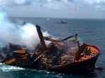 Smoke billows from the Singapore-registered container ship MV X-Press Pearl as it is towed away from the coast of Colombo on June 2 following Sri Lankan President Gotabaya Rajapaksa's order to move the ship to deeper water to prevent a bigger environmental disaster. (Sri Lanka Air Force / AFP)