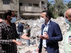 Robert Mardini, Director General of the International Committee of the Red Cross (ICRC), gestures as he speaks with a Palestinian man near the rubble of a house destroyed in Israeli airstrikes during Israeli-Palestinian fighting, in Gaza City on June 2, 2021. 