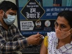 A health worker inoculates a woman with a dose of the Covishield vaccine at a civil hospital in Jind in Haryana. (AFP)