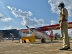 A policemen looks on as Aerialworks Aero LLP staff load liquid-based disinfectant on an air-plancein Bangalore on May 29, 2021. (AFP) A policemen looks on as Aerialworks Aero LLP staff load liquid-based disinfectant on an air-plancein Bangalore on May 29, 2021. (AFP)