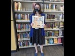 In this photo provided by Heights Libraries, Sara Phillips, a branch manager with Heights Libraries in Ohio, holds the Bob Dylan double album In this photo provided by Heights Libraries, Sara Phillips, a branch manager with Heights Libraries in Ohio, holds the Bob Dylan double album