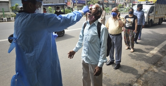 A health worker in PPE coveralls collects swab samples for Covid test, at Kirti Nagar in New Delhi. (Sanchit Khanna/ Hindustan Times) A health worker in PPE coveralls collects swab samples for Covid test, at Kirti Nagar in New Delhi. (Sanchit Khanna/ Hindustan Times)