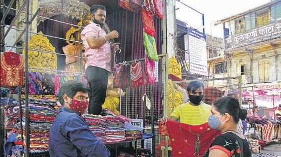 A customer at a non-essential shop that reopened at Tulshibaug, on Tuesday, after two months of lockdown. (RAVINDRA JOSHI/HT)