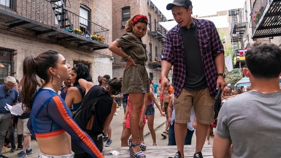 This image released by Warner Bros. Entertainment shows Melissa Barrera, from left, Daphne Rubin-Vega and director Jon M Chu on the set of In the Heights, which will be in theaters in the US on June 11. (AP)