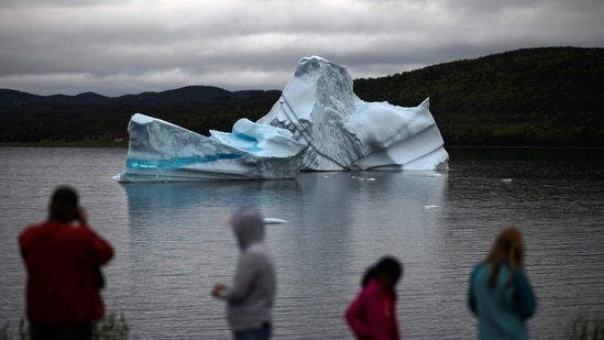 In this file photo taken on July 03, 2019 tourists watch an iceberg float near King's Point in Newfoundland, Canada. (AFP )