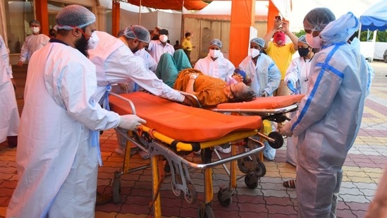 Health workers transfer a Covid-19 patient to LNJP Hospital from Sri Guru Teg Bahadur Covid-19 Care Centre, at Gurudwara Rakab Ganj Sahib in New Delhi. (Raj K Raj / Hindustan Times)