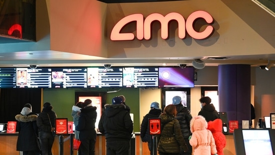 People line up for movie tickets at a reopened AMC theatre in New York. (Evan Agostini/Invision/AP)