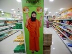 A hoarding with an image of Baba Ramdev is seen inside a Patanjali store. (REUTERS)