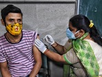 A health worker inoculates a differently abled beneficiary at Shastri Park in New Delhi. A health worker inoculates a differently abled beneficiary at Shastri Park in New Delhi.