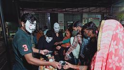 This group of volunteers from Bhopal distributes Covid-19 relief material while wearing the Anonymous mask.