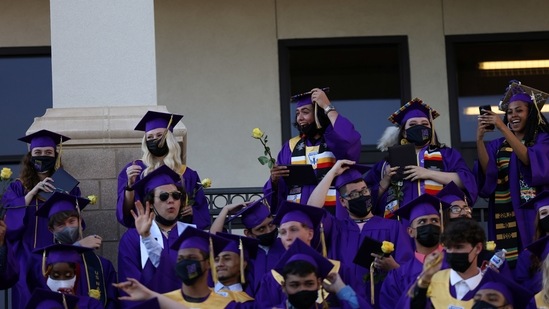 Shane Wolf, (C), 18, moves his tassel signifying his official graduation from high school in Denver, Colorado on May 27. Wolf, who was accepted to the University of Denver, said success once meant wealth. "But now I'm really focused on the environment," he said. "Because of my culture, my mom and my grandpa." "I feel like we as young people have this sense of urgency and responsibility," Wolf said. "This generation just has such a responsibility to really save this planet."(Kevin Mohatt / REUTERS)
