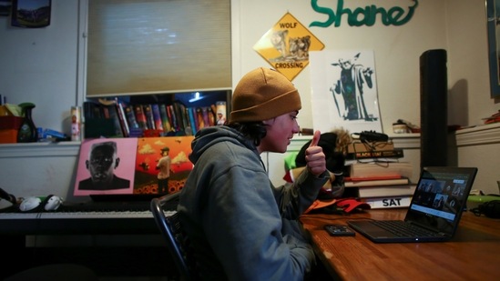 High school senior, Shane Wolf, 18, attends an online class in which Native American students meet regularly with a Lakota elder, Sid Whiting, in Denver, Colorado on March 19. Whiting, a Sican'gu Lakota northern traditional dancer and singer who mentors Native American Denver Public School students, said, young people want to know their heritage. "Their thirst for knowledge, it keeps me going. It keeps me on my toes."(Kevin Mohatt / REUTERS)