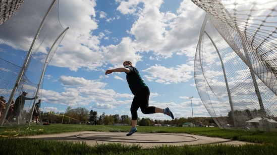 High school senior Megan Bickford, 17, throws the discus and sets a new school record at a track meet in Paris, Maine on May 13. Then came the pandemic, shutting schools and forcing students into isolation. Bickford, an athlete, worried about the impact of the cancellation of spring sports during her junior year, key for college recruiting. In the end, she earned a place at Swarthmore College in Pennsylvania.(Brian Snyder / REUTERS)