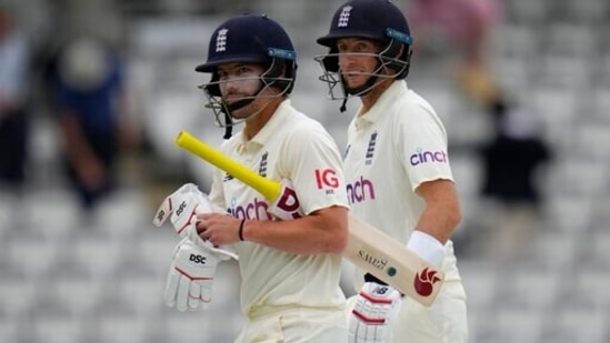 England's Rory Burns and England's Joe Root leave the pitch at the end of play on the second day of the Test against New Zealand(AP)