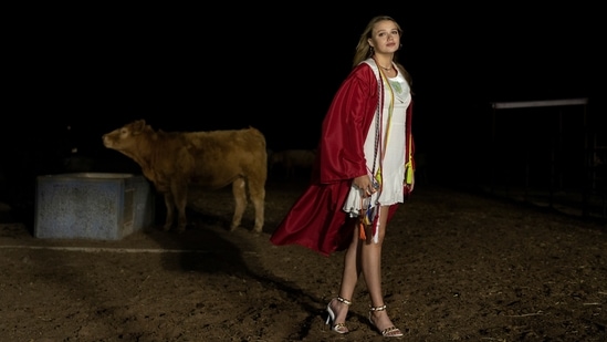 Kate Munson, 18, reacts on the ranch which her family owns, after her graduation ceremony at Shallowater High School in Shallowater, Texas on May 21. A seventh-generation rancher on the arid southern Plains, Munson wants to become a voice for rural America by studying agricultural communications and business, and then possibly getting a law degree.(Go Nakamura / REUTERS)