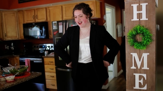High school senior Megan Bickford, 17, shows her prom outfit to her family at their home in Paris, Maine on May 15. As a young gay woman who is still exploring her identity, Megan said she watched in horror as the Trump administration took action to strip many LGBTQ Americans of their rights. But, Bickford said, she also felt emboldened to stand up for what she believes in.(Brian Snyder / REUTERS)