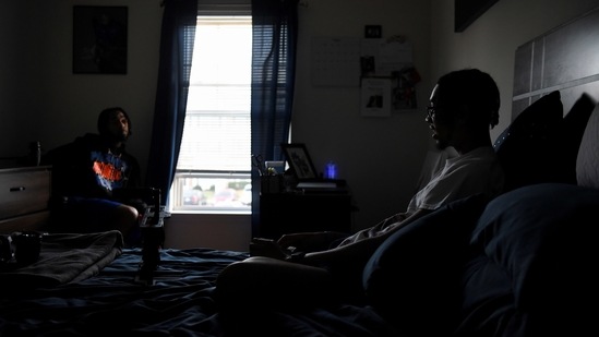 Jamari Prim, 18, who graduated a semester early and began taking classes at a local community college, talks with his brother in his bedroom in Raleigh, North Carolina on April 4. As a Black teenager living in Raleigh, Prim said he feared what the police might do to him or his friends far more than a virus. Prim said that kids his age felt the urgency of the tumultuous time in which they were raised.(Callaghan O'Hare / REUTERS)