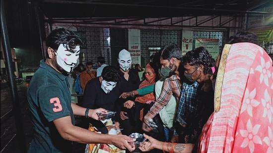 This group of volunteers from Bhopal distributes Covid-19 relief material while wearing the Anonymous mask. This group of volunteers from Bhopal distributes Covid-19 relief material while wearing the Anonymous mask.