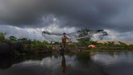 A fisherman casts his net as dark clouds hover in the sky in Kochi, on June 3. The monsoon arrives in Kerala first before covering the rest of India by July. (PTI) A fisherman casts his net as dark clouds hover in the sky in Kochi, on June 3. The monsoon arrives in Kerala first before covering the rest of India by July. (PTI)