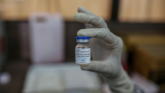 A nurse displays a vial of Bharat Biotech Ltd. Covaxin vaccine arranged at a Covid-19 vaccination centre at a municipal hospital in Pune.(Bloomberg)