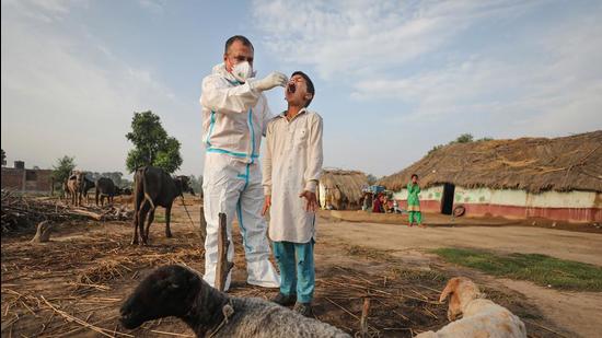 Jammu: A health worker collects swab samples of a Gujjar-Bakarwal community child for COVID-19 tests, on the outskirts of Jammu. (PTI)