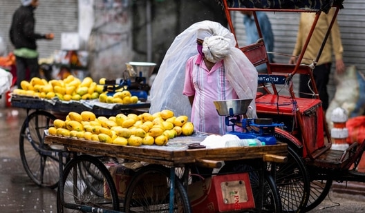 A fruit vendor waits for customers at a street in New Delhi (AFP) A fruit vendor waits for customers at a street in New Delhi (AFP)